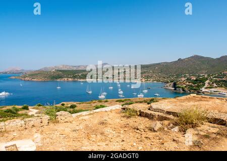 View of the bay and anchorage full of sailboats from Temple of Poseidon at Cape Sounion on sunny day, Sounion, Greece. Stock Photo