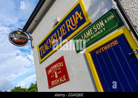 McCaffertys Bar and restaurant on Wild Atlantic Way, Dungloe, County Donegal, Ireland. Signs, and signage on exterior wall. Stock Photo