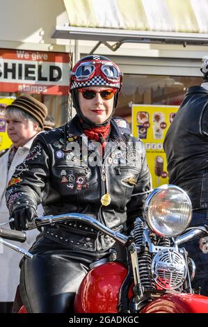 Female motorcyclist in retro black leathers at the Goodwood Revival event.. Vintage, classic, timeless. Step back in time nostalgia Stock Photo