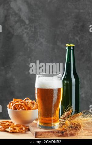 Lager beer and snacks on stone table. Cracker, chips side view Stock Photo