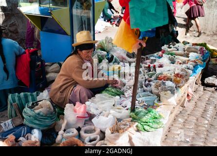 Pisac, Peru - July 29 2010: Elderly Local Woman Selling Spices at the Open Air Market. Stock Photo