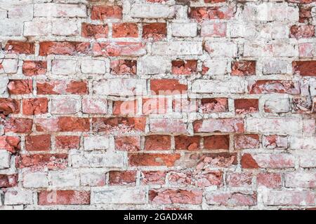 Old brick breaking old wall texture with elements of white gray concrete Stock Photo