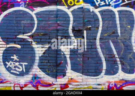 Wall with colored graffiti with letters. Stock Photo