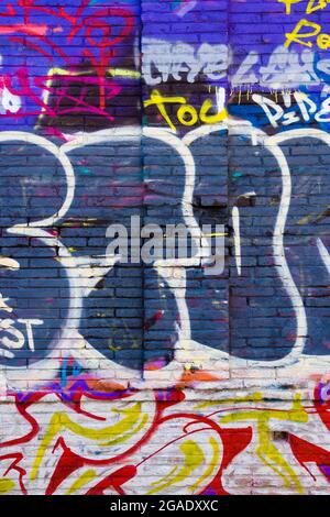 Wall with colored graffiti with letters. Stock Photo