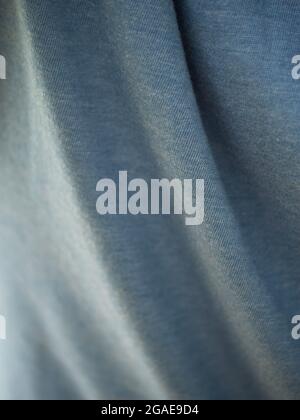 Gray folded fabric, close-up. Fabric texture. Fabric folds. Stock Photo
