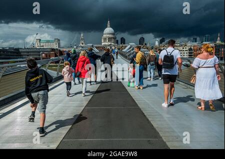 London, UK. 30th July, 2021. Sunshine and showers, unpredictable weather on the Millennium Bridge. Credit: Guy Bell/Alamy Live News