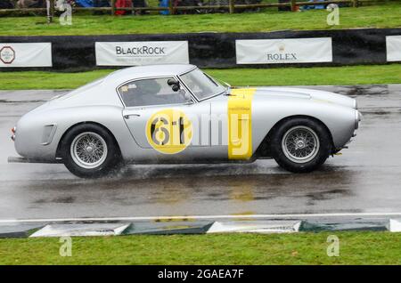 Ferrari 250 GT SWB Berlinetta racing car competing in the RAC Tourist Trophy Celebration endurance race at the Goodwood Revival 2013 in wet conditions Stock Photo