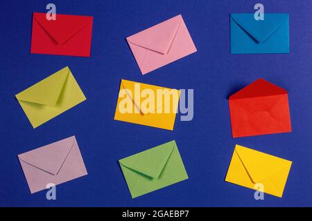 Top view to colorful envelopes displayed on blue background, top view Stock Photo