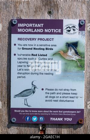 Notice on the edge of an upland moor asking people to be aware of ground nesting birds. North Yorkshire, UK. Stock Photo