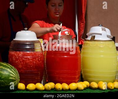 A young woman dispenses fresh squeezed juices at a festival food stand in Santea Fe, Newe Mexico. Stock Photo