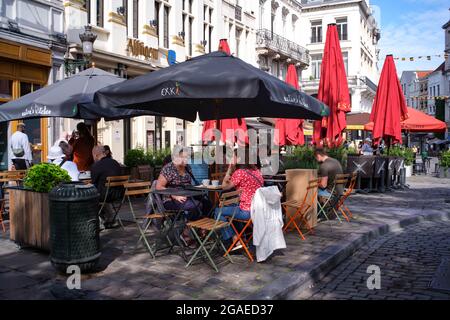 Brussels, Belgium. 30th July, 2021. People are seen at a cafe in Brussels, Belgium, July 30, 2021. In the second quarter 2021, seasonally adjusted GDP increased by 2.0 percent in the euro area and by 1.9 percent in the EU, compared with the previous quarter, according to a preliminary flash estimate published by Eurostat, the statistical office of the European Union. Credit: Zhang Cheng/Xinhua/Alamy Live News Stock Photo