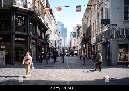 Brussels, Belgium. 30th July, 2021. People walk on a shopping street in Brussels, Belgium, July 30, 2021. In the second quarter 2021, seasonally adjusted GDP increased by 2.0 percent in the euro area and by 1.9 percent in the EU, compared with the previous quarter, according to a preliminary flash estimate published by Eurostat, the statistical office of the European Union. Credit: Zhang Cheng/Xinhua/Alamy Live News Stock Photo