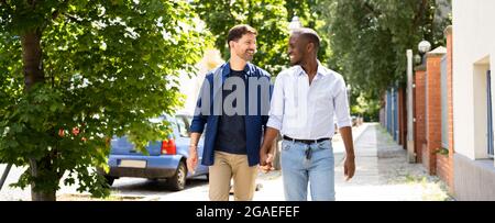 Gay Couple Dating In Jeans. Walking On Street In City Stock Photo