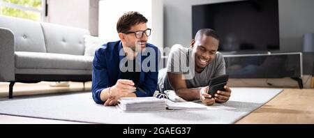 Happy Gay Couple Doing Taxes And Income Planning With Calculator Stock Photo