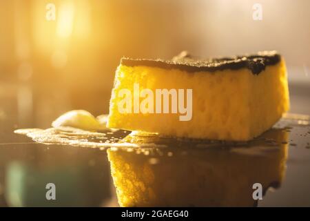 Close-up to dish kitchen sponge in home kitchen interior, housework background Stock Photo