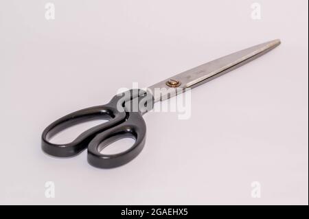 large pair of used wall paper scissors on a white background Stock Photo
