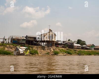 Belen, Peru - Sep 2017: Church and other houses on stilts in the floodplain of the Itaya River, the poorest part of Iquitos - Belén. Venice of Latin A Stock Photo