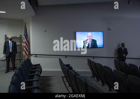 Washington, United States. 30th July, 2021. President Joe Biden is seen on a television screen speaking during a virtual meeting with Vice President Kamala Harris and Governors to discuss wildfire prevention, preparedness and response efforts at the Eisenhower Executive Office Building near the White House in Washington, DC, on Friday, July 30, 2021. Photo by Sarah Silbiger/UPI Credit: UPI/Alamy Live News Stock Photo