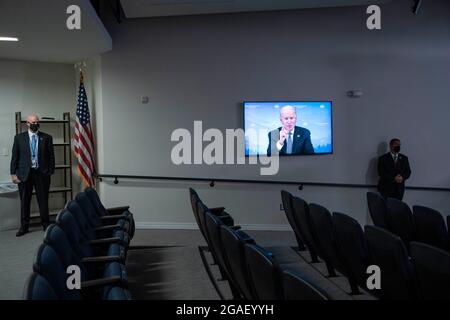 Washington, United States. 30th July, 2021. President Joe Biden is seen on a television screen speaking during a virtual meeting with Vice President Kamala Harris and Governors to discuss wildfire prevention, preparedness and response efforts at the Eisenhower Executive Office Building near the White House in Washington, DC, on Friday, July 30, 2021. Photo by Sarah Silbiger/Pool/Sipa USA Credit: Sipa USA/Alamy Live News Stock Photo