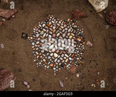 A stone or rock sculpture pattern in the sand on the beach, Dunbar, East Lothian, Scotland, UK Stock Photo