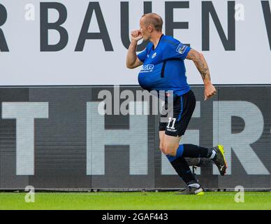 Paderborn, Germany. 30th July, 2021. Soccer: 2nd Bundesliga, SC Paderborn 07 - 1. FC Nürnberg, Matchday 2. Paderborn's Sven Michel celebrates the goal with the ball under his jersey to make it 2:2. Credit: Guido Kirchner/dpa - IMPORTANT NOTE: In accordance with the regulations of the DFL Deutsche Fußball Liga and/or the DFB Deutscher Fußball-Bund, it is prohibited to use or have used photographs taken in the stadium and/or of the match in the form of sequence pictures and/or video-like photo series./dpa/Alamy Live News Stock Photo