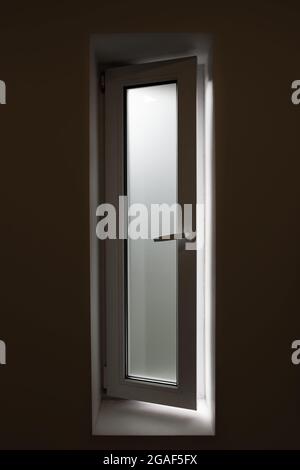 Bathroom window with frosted glass, light shining though but can not see though, privacy concept. Stock Photo