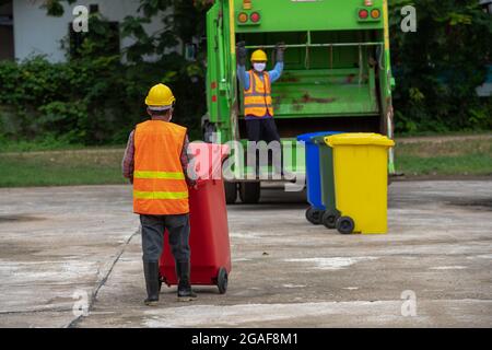 Garbage collectors work together as a team. Stock Photo