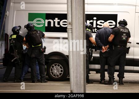 Police officers detain people following a shooting in Berlin, Germany, July 30, 2021. REUTERS/Christian Mang