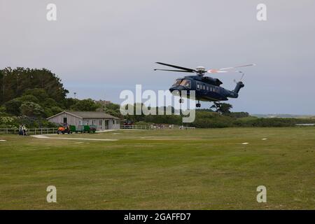 Helicopter leaving Tresco heliport, Tresco island, Isles of Scilly, Cornwall, England, UK, July 2021 Stock Photo