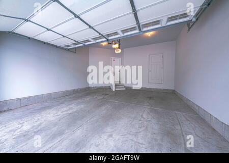 Interior of a garage with over the canopy garage door with window panels Stock Photo