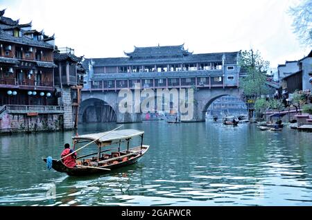 Enjoying a boat ride in Tuo River in Ancient Town of Fenghuang, Hunan, China Stock Photo