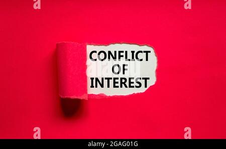 Conflict of interest symbol. Words 'Conflict of interest' appearing behind torn purple paper. Beautiful purple background. Business, conflict of inter Stock Photo