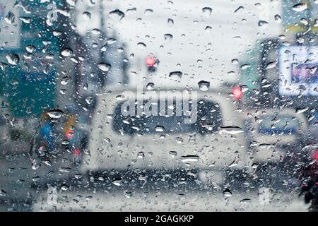 Raindrops on windshield from inside the car in traffic jam Stock Photo