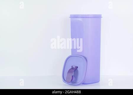 A large plastic purple water container with detached top cover on white background Stock Photo