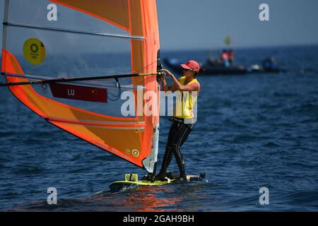 Kanagawa, Japan. 31st July, 2021. Lu Yunxiu of China prepares for the women's windsurfer RS:X medal race at the Tokyo 2020 Olympic Games in Kanagawa, Japan, July 31, 2021. Credit: Huang Zongzhi/Xinhua/Alamy Live News Stock Photo