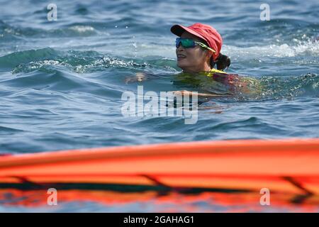 Kanagawa, Japan. 31st July, 2021. Lu Yunxiu of China celebrates after the women's windsurfer RS:X medal race at the Tokyo 2020 Olympic Games in Kanagawa, Japan, July 31, 2021. Credit: Huang Zongzhi/Xinhua/Alamy Live News Stock Photo