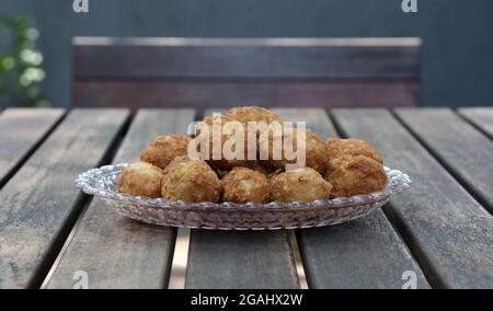 gemblong is one of the traditional Indonesian cakes made from glutinous rice flour, grated coconut, oval in shape coated with liquid brown sugar after Stock Photo