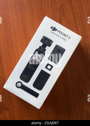 Dubai, United Arab Emirates - 25th December, 2020 - Dji Pocket 2 creator combo package resting on a brown wooden table. Stock Photo