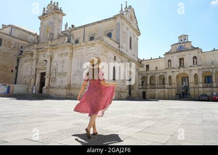 Beautiful young woman walking in the Cathedral Square of the Baroque City of Lecce, Salento, Italy Stock Photo