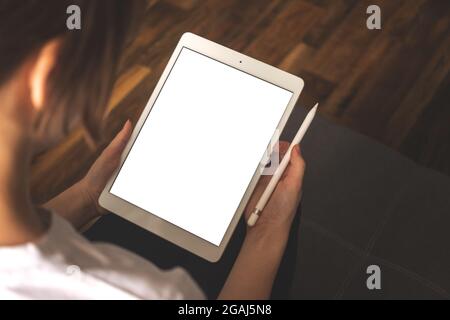 Woman hand on a mockup tablet with pencil, freelancer work job concept background Stock Photo