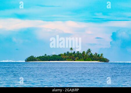 Small island in tropical sea against sky with clouds background.The Laccadive Sea or Lakshadweep Sea is a body of water bordering India, the Maldives, Stock Photo