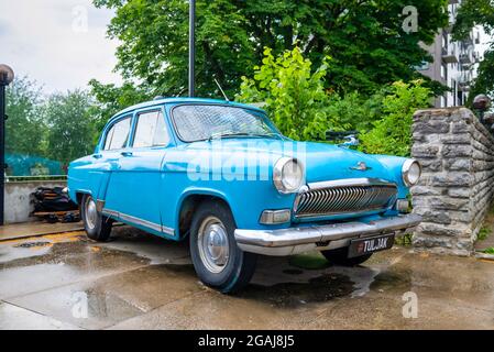 Close-up view of the old russian car GAZ-21 Volga parked in the yard. Stock Photo
