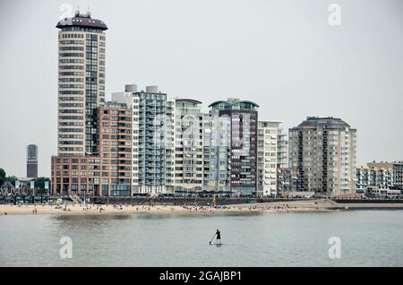 Vlissingen, The Netherlands, July 24, 2021: stand-up paddleboarder on the Northsea in front of the city's modern skyline Stock Photo