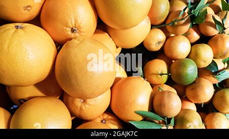 https://l450v.alamy.com/450v/2gajk7c/a-lot-of-fresh-yellow-mandarin-with-green-leaves-in-the-market-fruits-background-art-image-with-green-leaves-healthy-eating-concept-can-be-used-as-2gajk7c.jpg