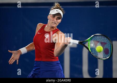 Marketa Vondrousova of Czech Republic returns a shot to Belinda Bencic of Switzerland during the gold medal match of the tennis competition at the 202 Stock Photo