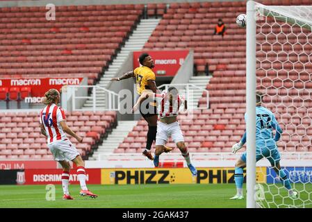 Stoke On Trent, UK. 31st July, 2021. Adama Traore of Wolverhampton Wanderers (37) heads the ball but his effort goes wide. Pre-season friendly match, Stoke City v Wolverhampton Wanderers at the Bet365 Stadium in Stoke on Trent on Saturday 31st July 2021. this image may only be used for Editorial purposes. Editorial use only, license required for commercial use. No use in betting, games or a single club/league/player publications.pic by Chris Stading/Andrew Orchard sports photography/Alamy Live News Credit: Andrew Orchard sports photography/Alamy Live News Stock Photo