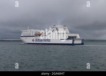 The Brittany ferry MONT ST MICHEL leaving harbour under a dark grey sky Stock Photo