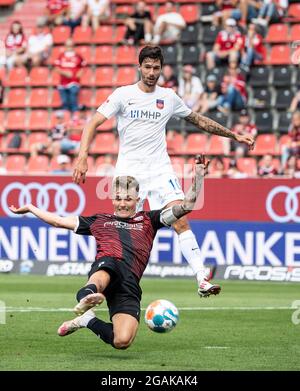 Ingolstadt, Germany. 31st July, 2021. Football: 2. Bundesliga, FC Ingolstadt 04 - 1. FC Heidenheim, Matchday 2 at Audi Sportpark. Dennis Eckert of Ingolstadt (below) and Tim Kleindienst of Heidenheim in a duel for the ball. Credit: Matthias Balk/dpa - IMPORTANT NOTE: In accordance with the regulations of the DFL Deutsche Fußball Liga and/or the DFB Deutscher Fußball-Bund, it is prohibited to use or have used photographs taken in the stadium and/or of the match in the form of sequence pictures and/or video-like photo series./dpa/Alamy Live News Stock Photo