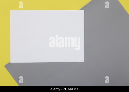 Blank Flyer paper on illuminating yellow and Ultimate Gray pastel paper background. Stock Photo