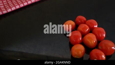 Cooking background, home cooking concept. Ripe tomatoes, spoon, herbs and spices on wooden background, top view Stock Photo